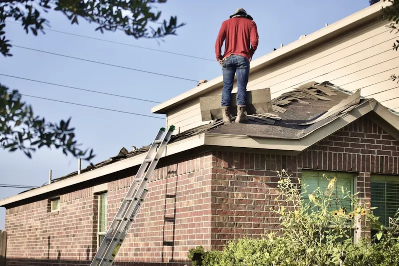 Professional roofer working on a residential roof in Browntown